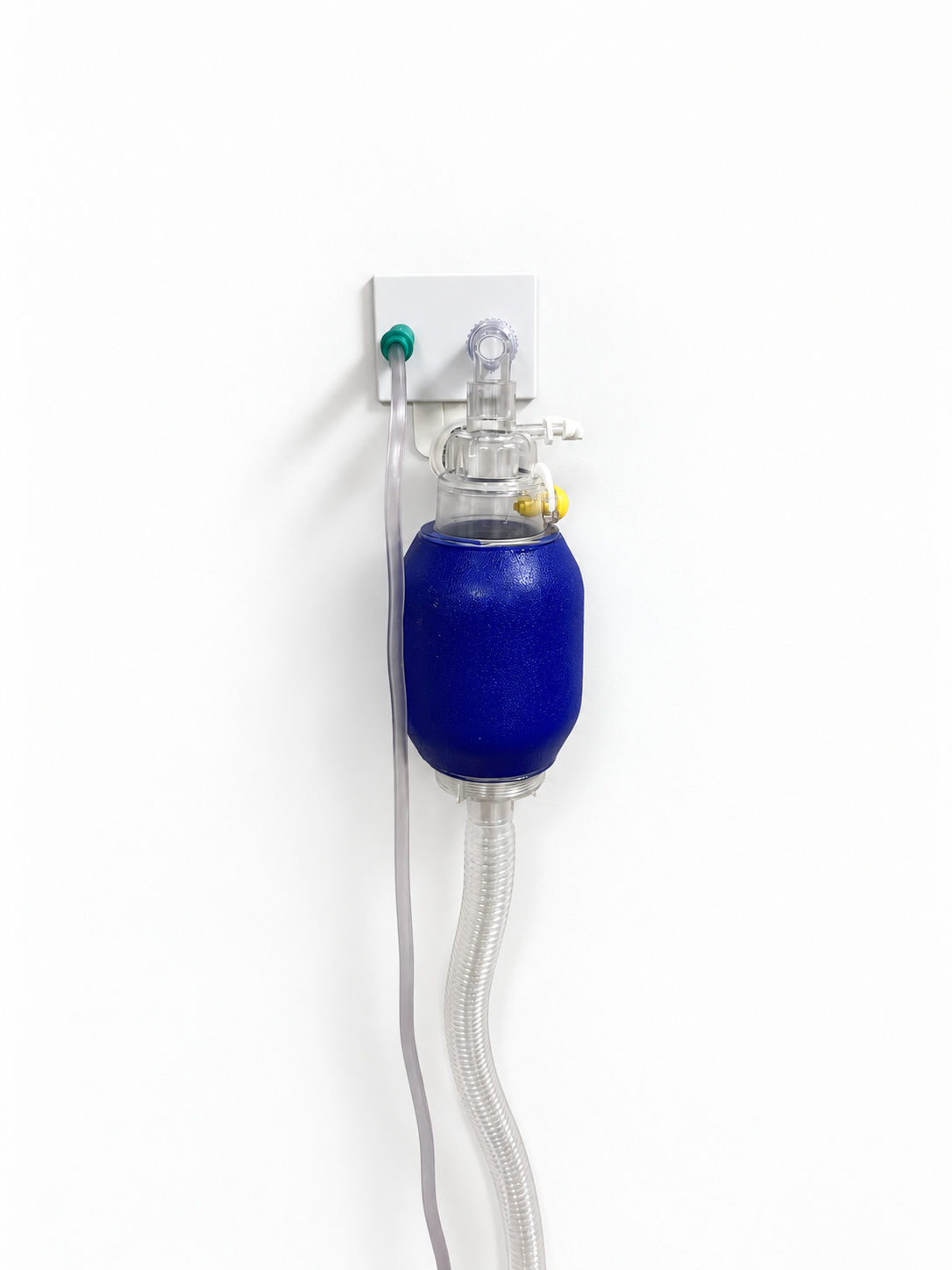 Wall-mounted Oxinest holding a blue bag valve mask beside a suction tube